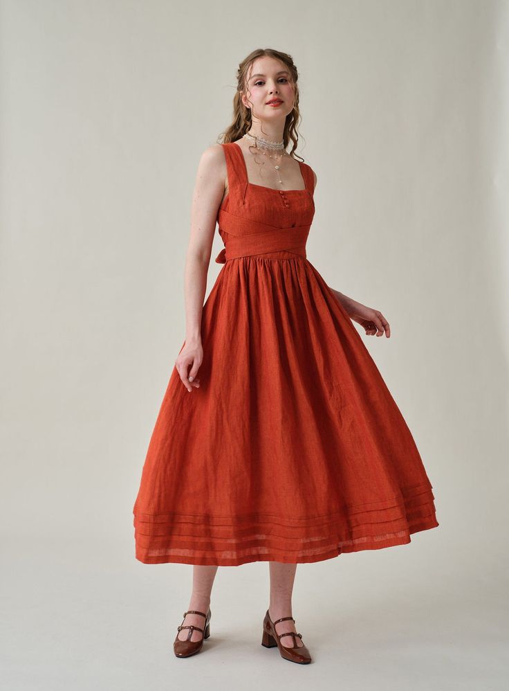 Summer calls for a crisp dress and this cross-back dress from Linennaive is pretty perfect. Made from breezy linen, it has comfortable cross back that'll really let skin breathe. Featuring a a classic square neckline and pleated detailing, evoking the laidback rhythms of far-off islands and unexplored landscapes. It en 70s Orange Dress, Linen Cocktail Dress, Picnic Sundress With Square Neck, Sleeveless Tea Length Dress For Summer Garden Party, Vintage Linen Dress With Square Neck, Elegant Square Neck Picnic Dress, Elegant Sleeveless Midi Dress For Picnic, Linen Dresses For Picnic, Spring Linen Dress For Picnic