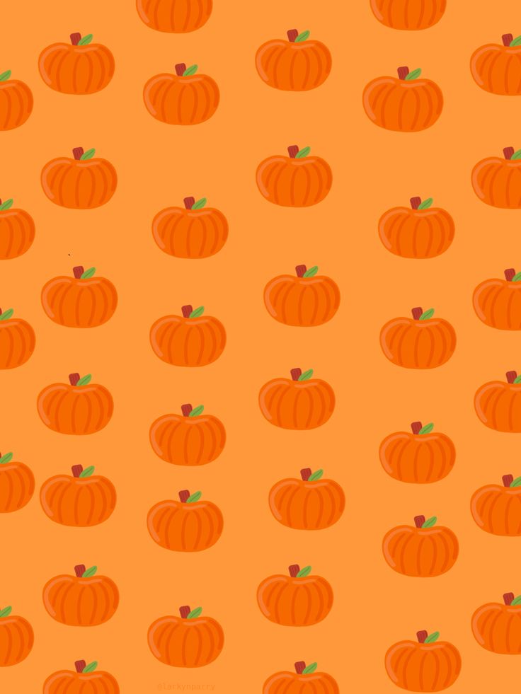 an orange background with small pumpkins on it