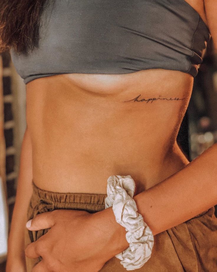 a woman with a tattoo on her stomach