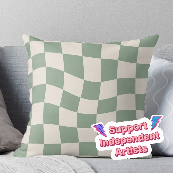 a green and white checkerboard pillow with the words support independent artists on it