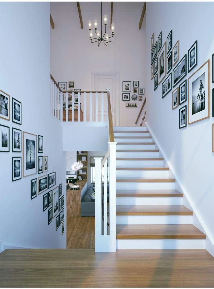 there is a staircase with pictures on the wall