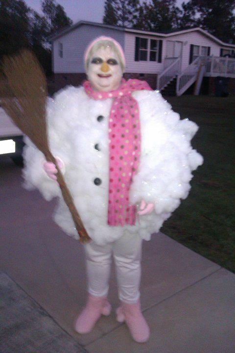 a person dressed as a snowman holding a broom