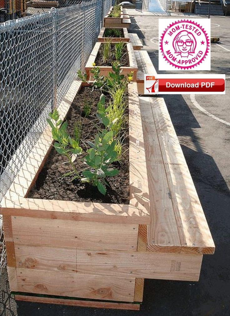 a row of wooden planters sitting next to a fence