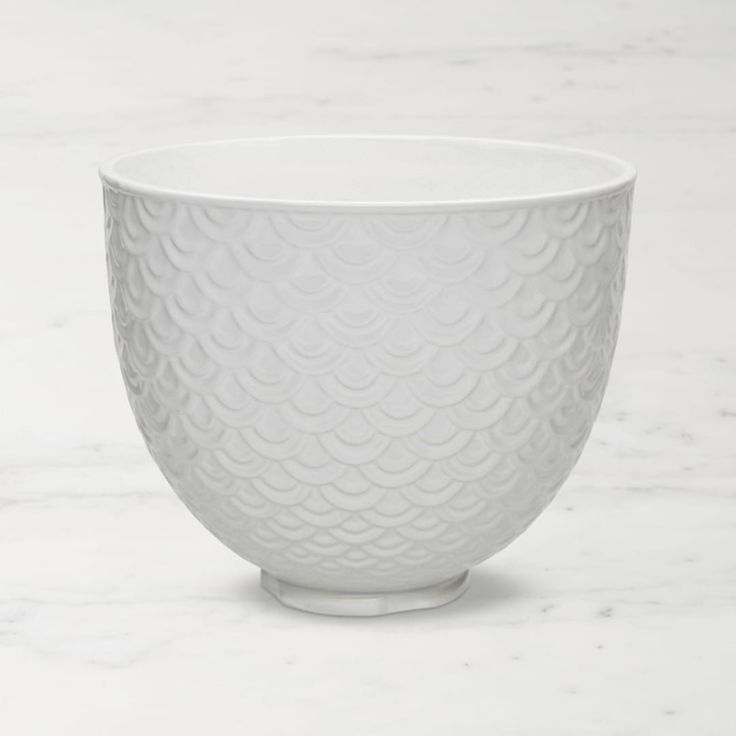 a white bowl sitting on top of a marble counter