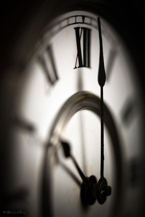 a black and white photo of a clock face