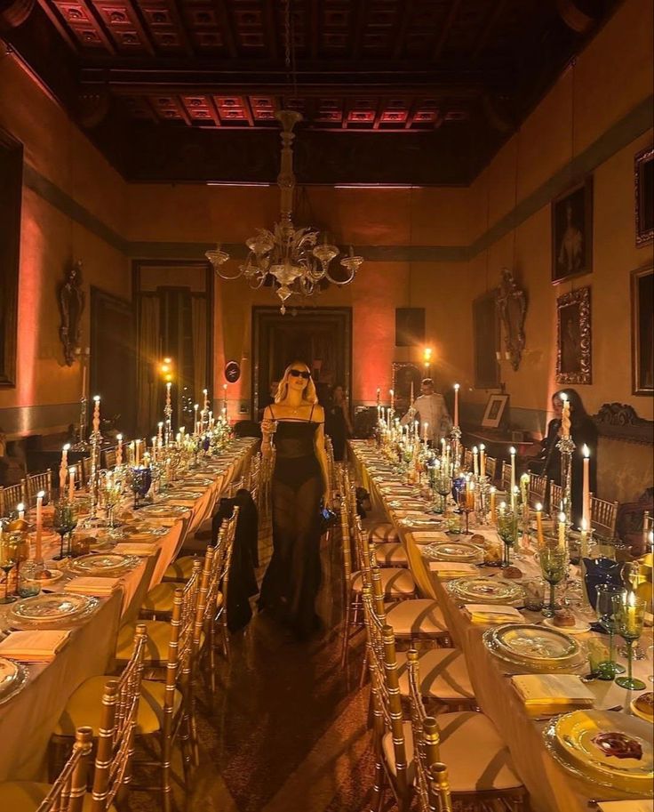 a long table is set with candles and plates