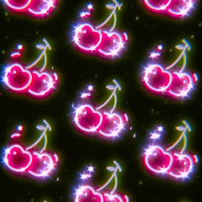 an image of neon cherries in the dark with stars and sparkles on them