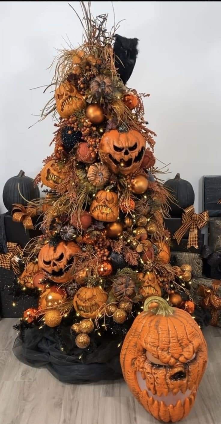 a decorated halloween tree with pumpkins and other decorations