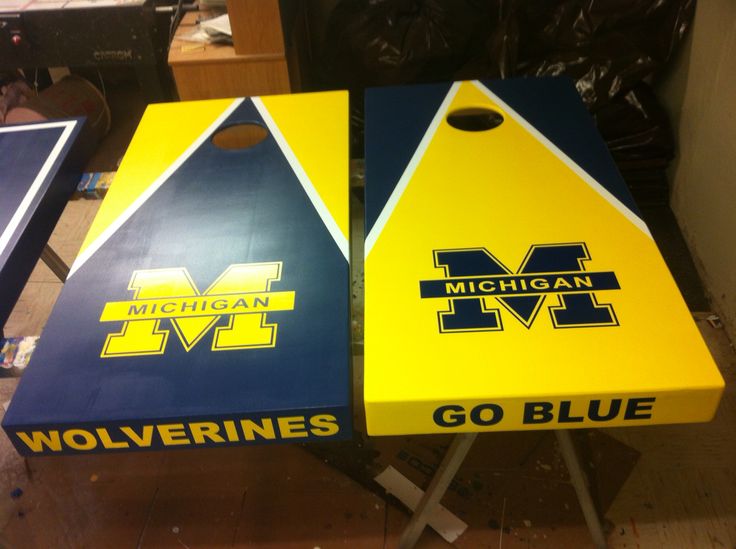 two michigan wolverines cornhole game boards sitting on top of a table in a room