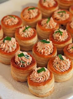 small appetizers are arranged on a white platter