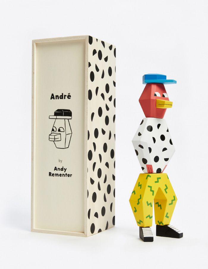 a toy chicken next to a book with black and white polka dots on it's cover