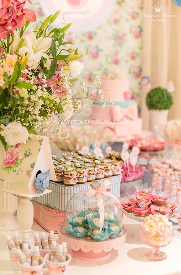 a table topped with lots of desserts and cupcakes