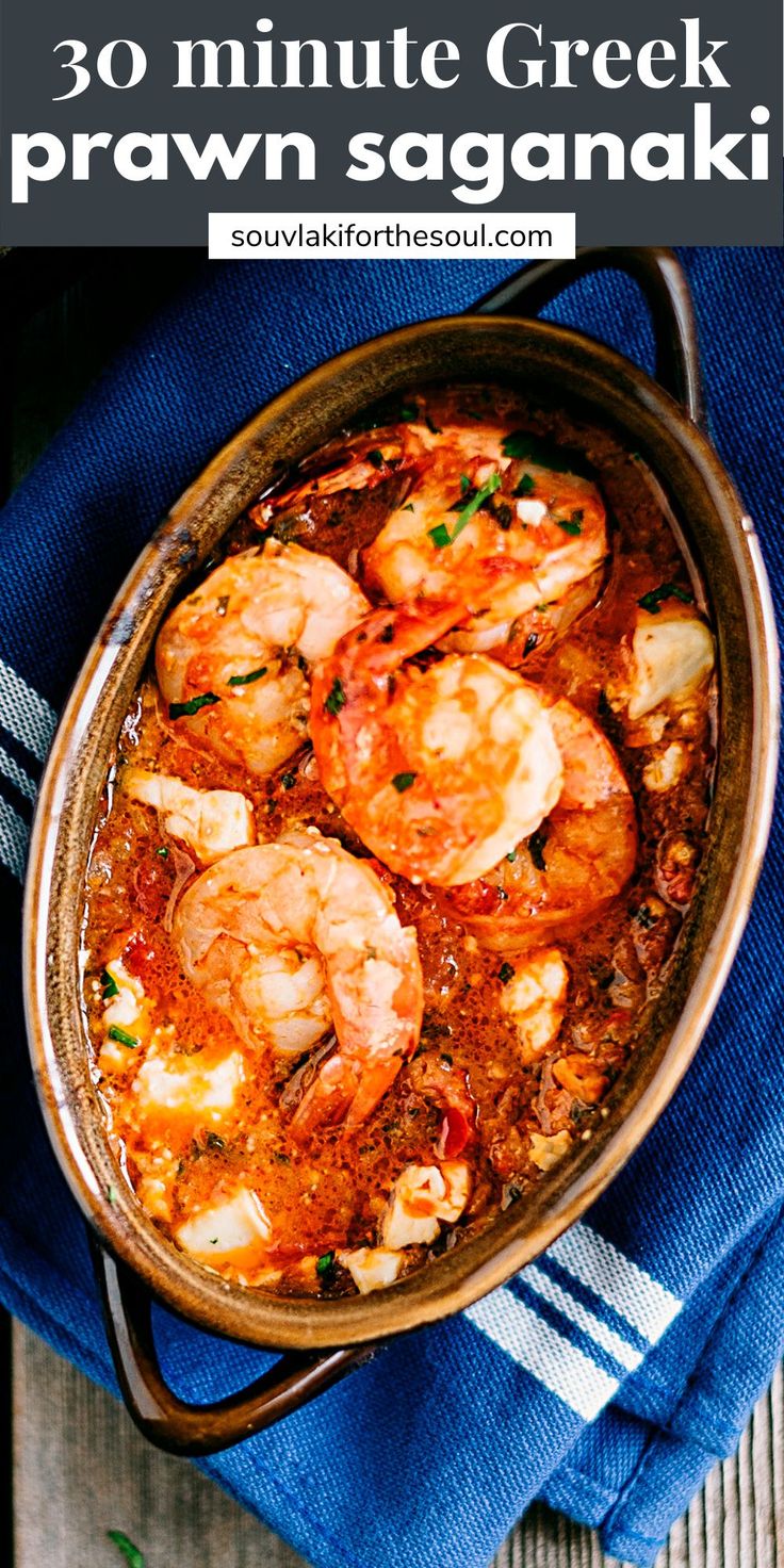 a pan filled with shrimp and sauce on top of a blue towel