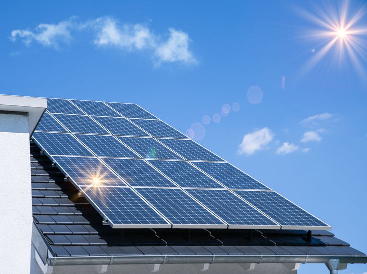 a solar panel on the roof of a building with blue sky in the back ground