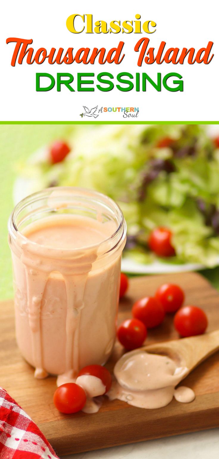 a close up of a jar of dressing on a cutting board with tomatoes and lettuce