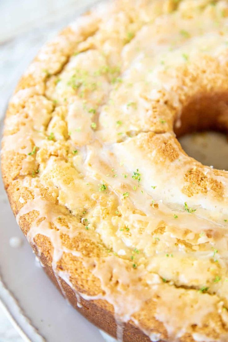 a close up of a doughnut with icing and sprinkles on a plate