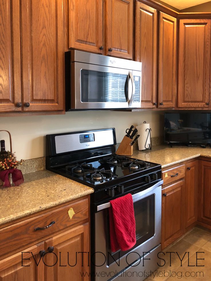 a kitchen with wooden cabinets and stainless steel appliances