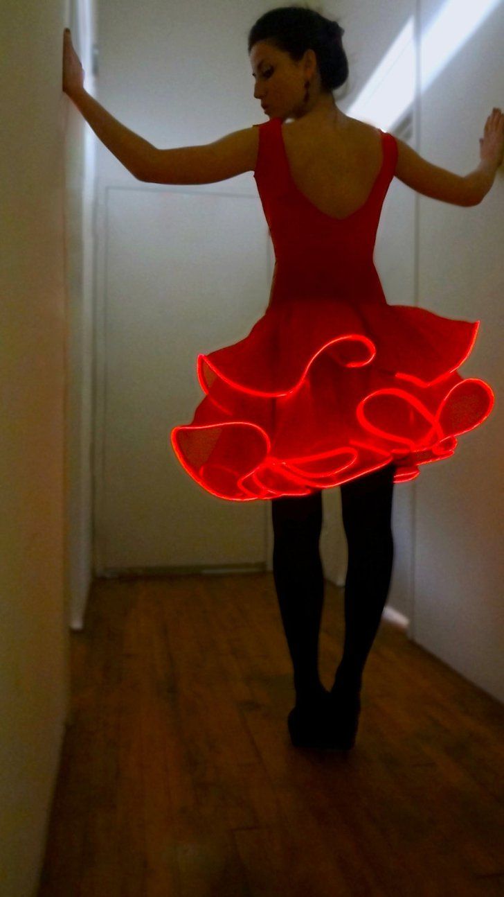 a woman in a red dress is dancing