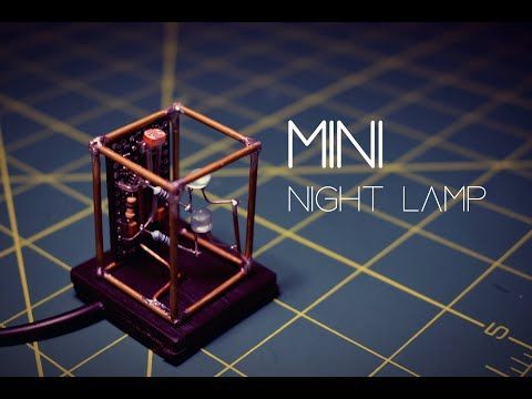 a mouse trap sitting on top of a table next to the words mini night lamp