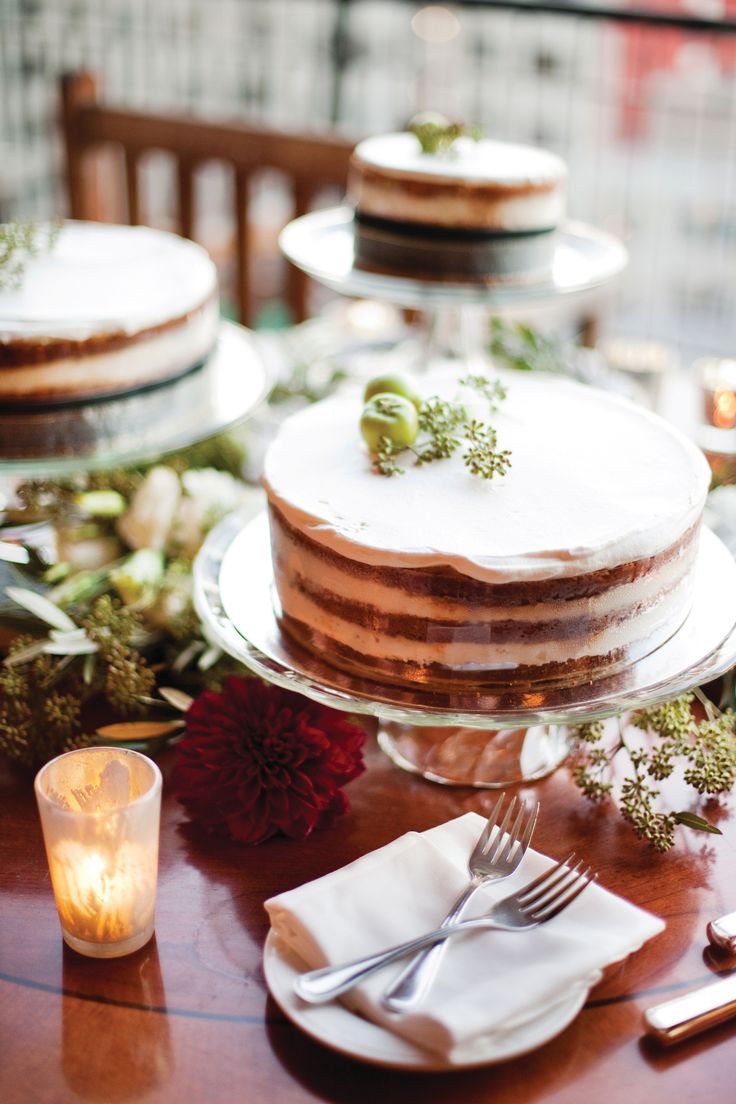 there is a cake on the table with silverware next to it and candles in front of it