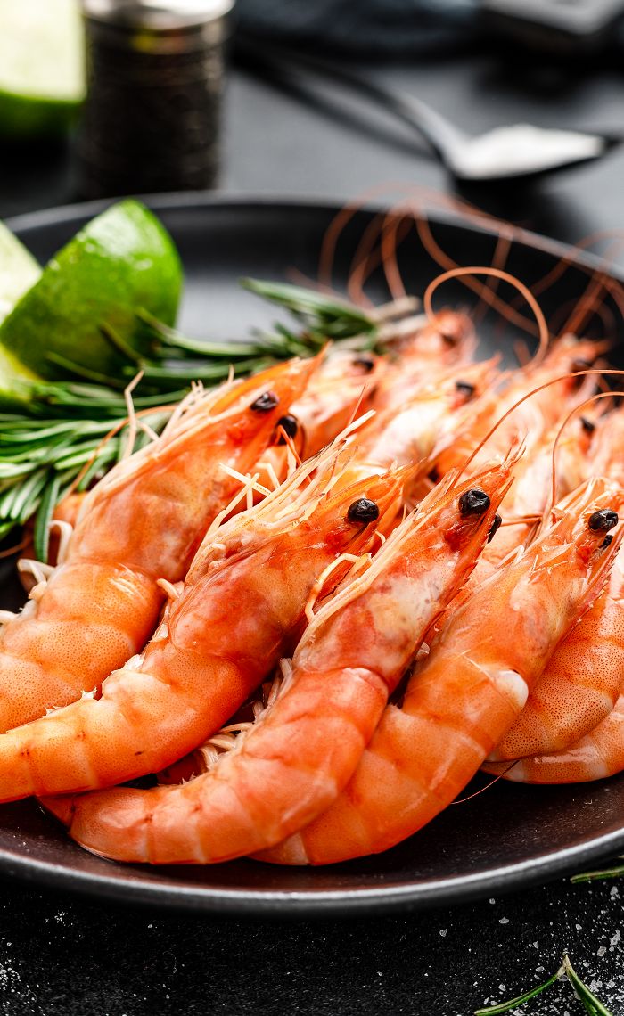 some shrimp are on a plate with herbs