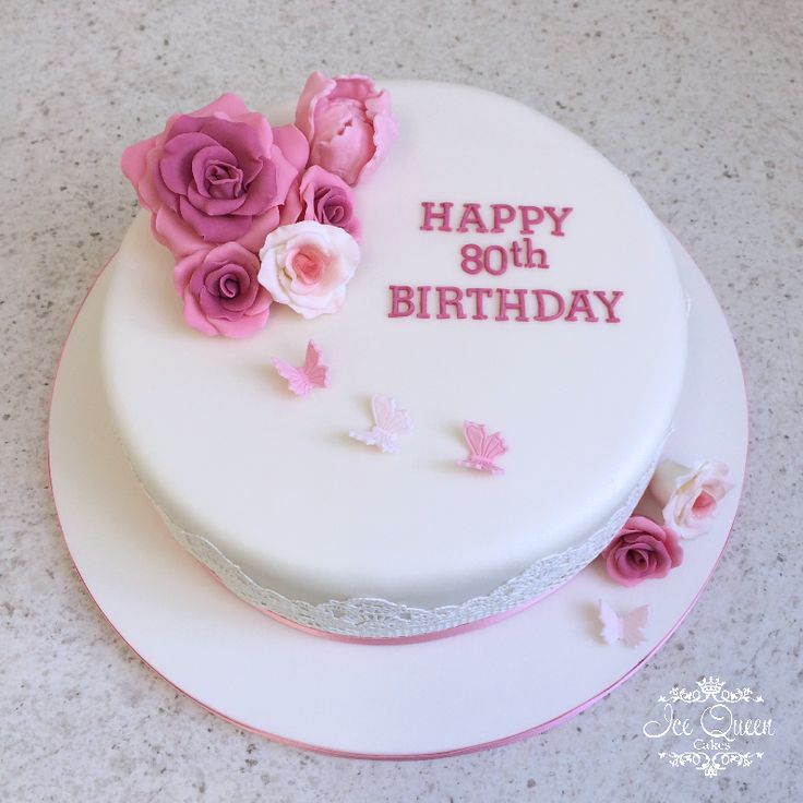 a white birthday cake with pink flowers on top