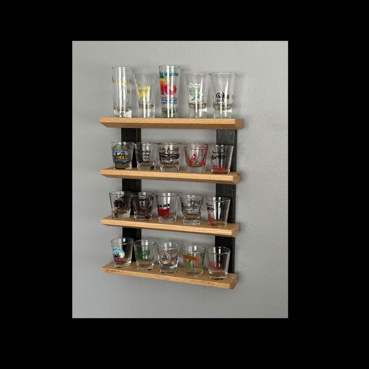 the shelves are filled with glasses and shot glasses on top of each other for storage