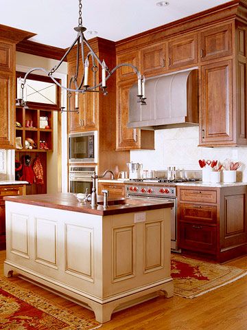 a kitchen with wooden cabinets and an island