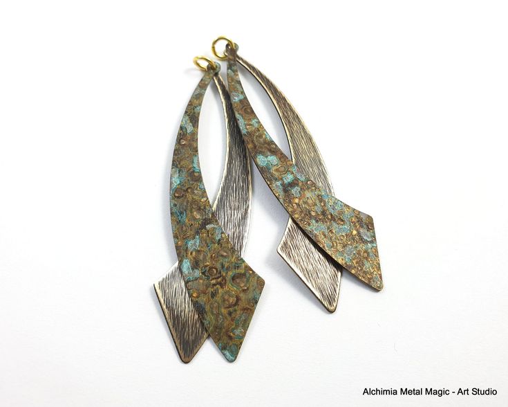 "Each blank is one of a kind, with unique patina colors and textures.  Raw brass hole blanks to create your own jewel set (earrings, pendants)  Patina is on both sides of the blank. Metal - raw brass Size - 60x13 mm / 2.3\"x0.5\" Quantity - 9 PAIRS ONLY I made the photo on my workbench on my mobile phone and the pictures have not been enhanced. So, you can see the real colors of the patina! The patina's colors are natural, and no harsh chemicals are used.   The brass/copper blanks are covered by a thin layer of lacquer in order to save the natural color of the patina.  You can add additional layers of lacquer to protect the finish further.  The plate of this gauge is perfect for creating a jewelry set (pendant, earrings etc.) or can be used for creating decorative elements for accessories. Patina Color, Set Earrings, Earring Charms, Handmade Boho, Raw Brass, Charm Earrings, Jewelry Set, Patina, Dangle Earrings