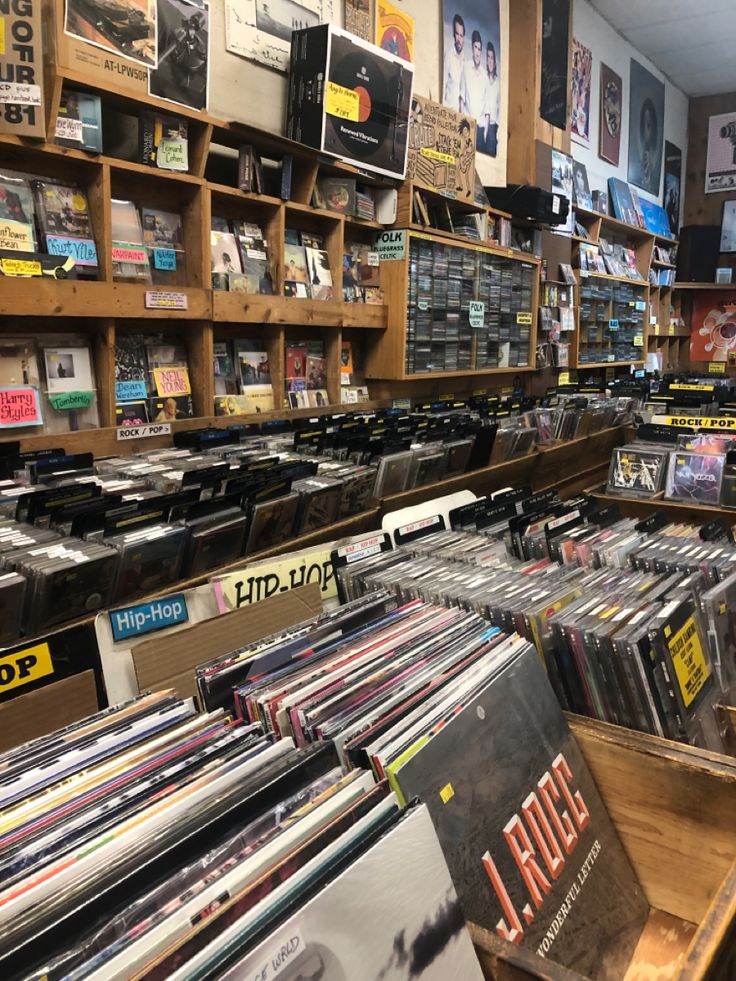 a record store filled with lots of records and cds on shelves next to each other