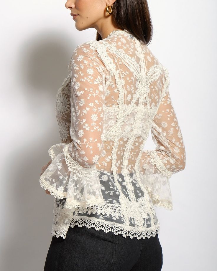 The Colette lace blouse features a delicate fitted V neckline top with ¾ sleeves and Venise lace collage all thru-out. The Colette comes with a lace bralette. Cotton and Rayon tulle lace Five satin buttons along bustline center front Dry clean only Each piece is made to order and handcrafted in our atelier. Slight variations may occur as each piece is unique. Spring Lace For Formal Occasions, Sheer Feminine Lace Top, Elegant Long Sleeve Spring Lace, Elegant Long Sleeve Lace For Spring, Feminine Lace For Spring, Fitted Feminine Lace For Spring, Spring Long Sleeve Lace With Lace Trim, Chic Lace Blouse With Delicate Details, Spring Formal Lace Patchwork Top