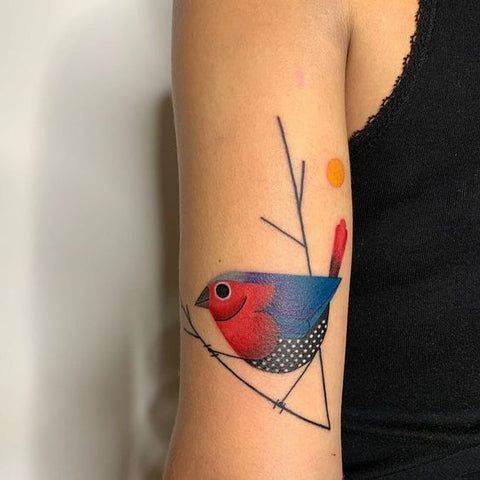 a colorful bird tattoo on the right arm and shoulder, with an orange dot in the center