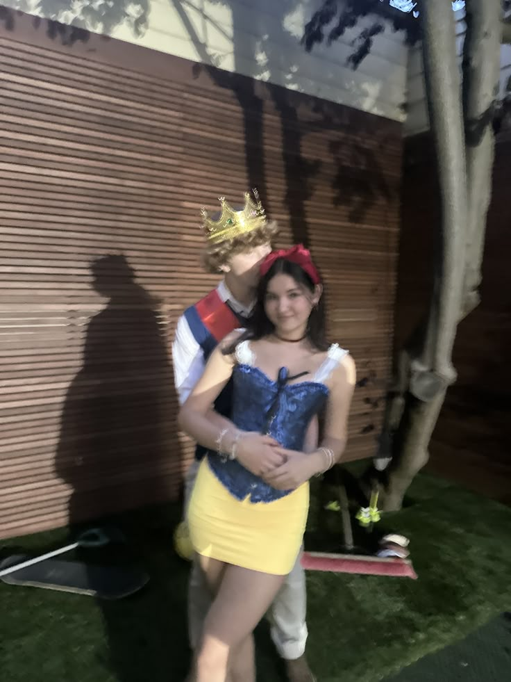 a man and woman dressed up as snow white and prince charmingly pose for the camera