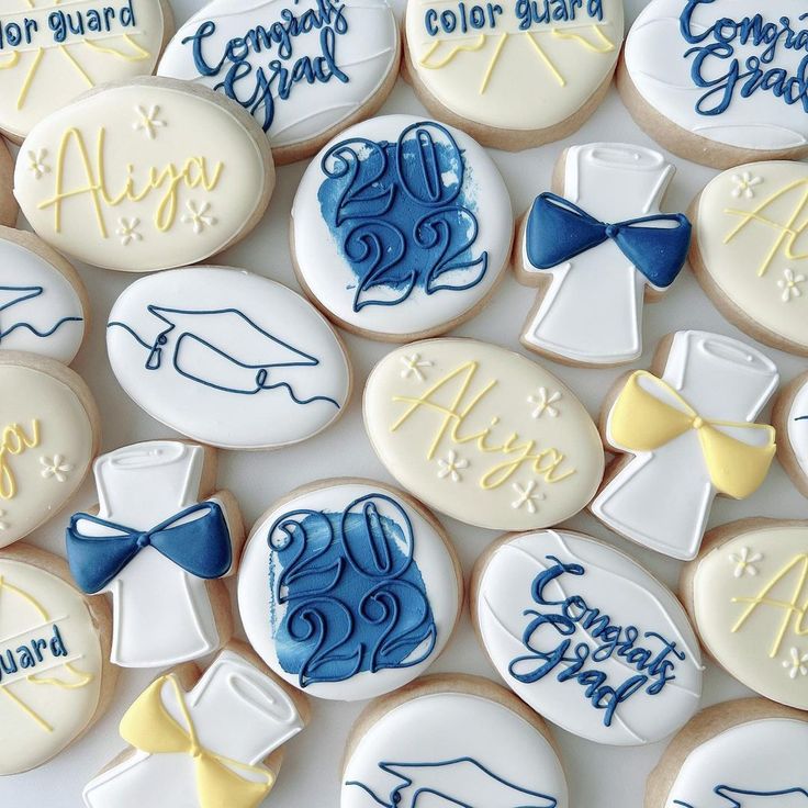 some cookies with blue and white icing on top of each other in the shape of letters