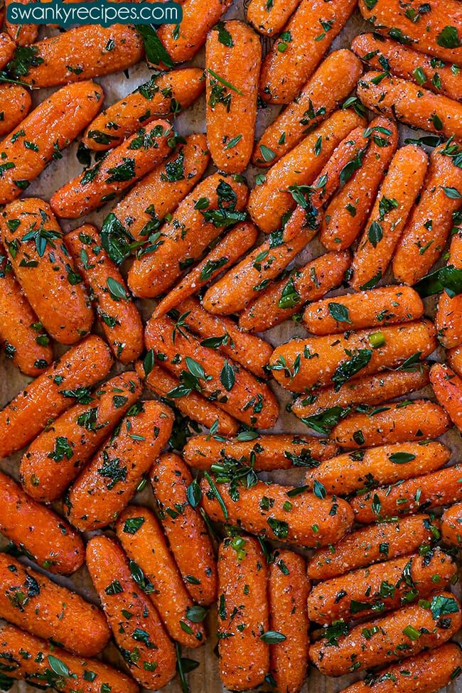 there are many carrots that have been cooked and garnished with parsley