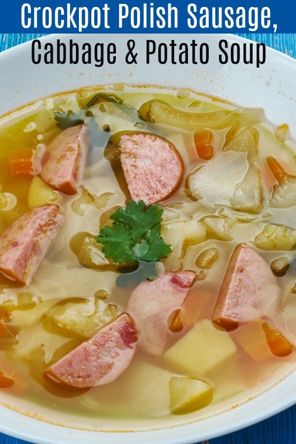 a white bowl filled with cabbage and potato soup on top of a blue wooden table