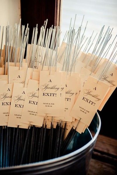 a bunch of tags that are in a bucket on a table with some sticks sticking out of it