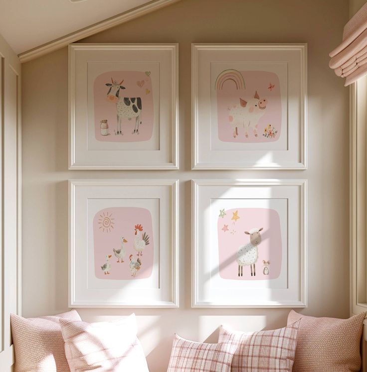 four framed pictures hang on the wall above a couch in a room with pink walls