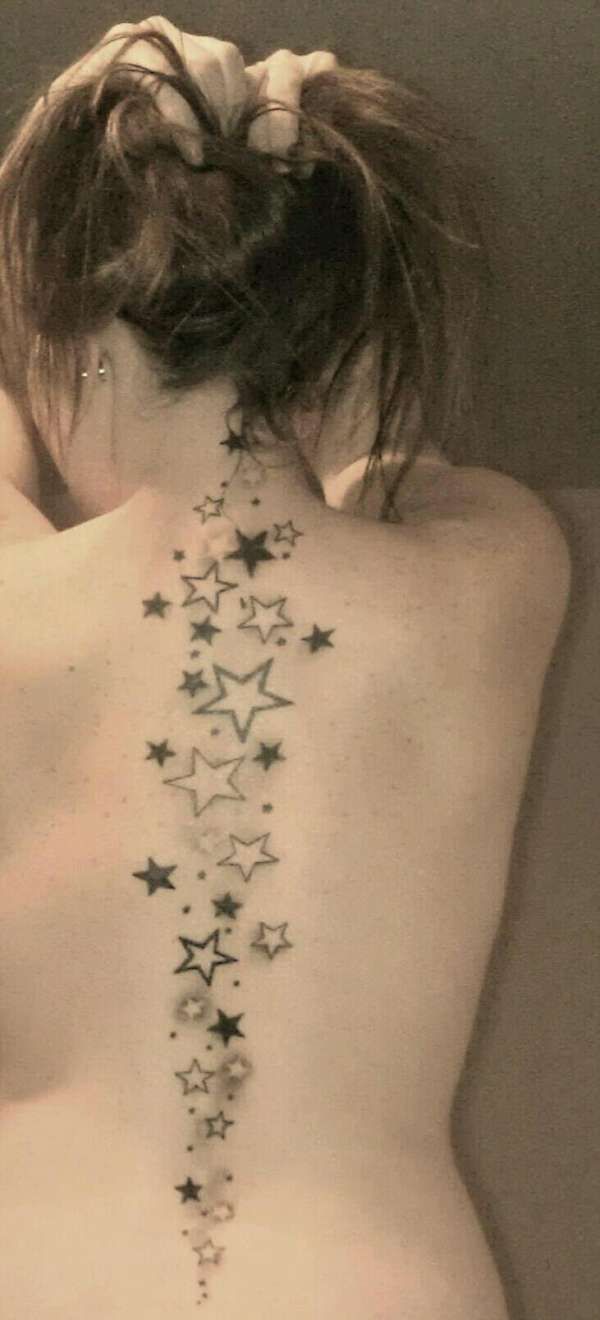 the back of a woman's body with stars on it