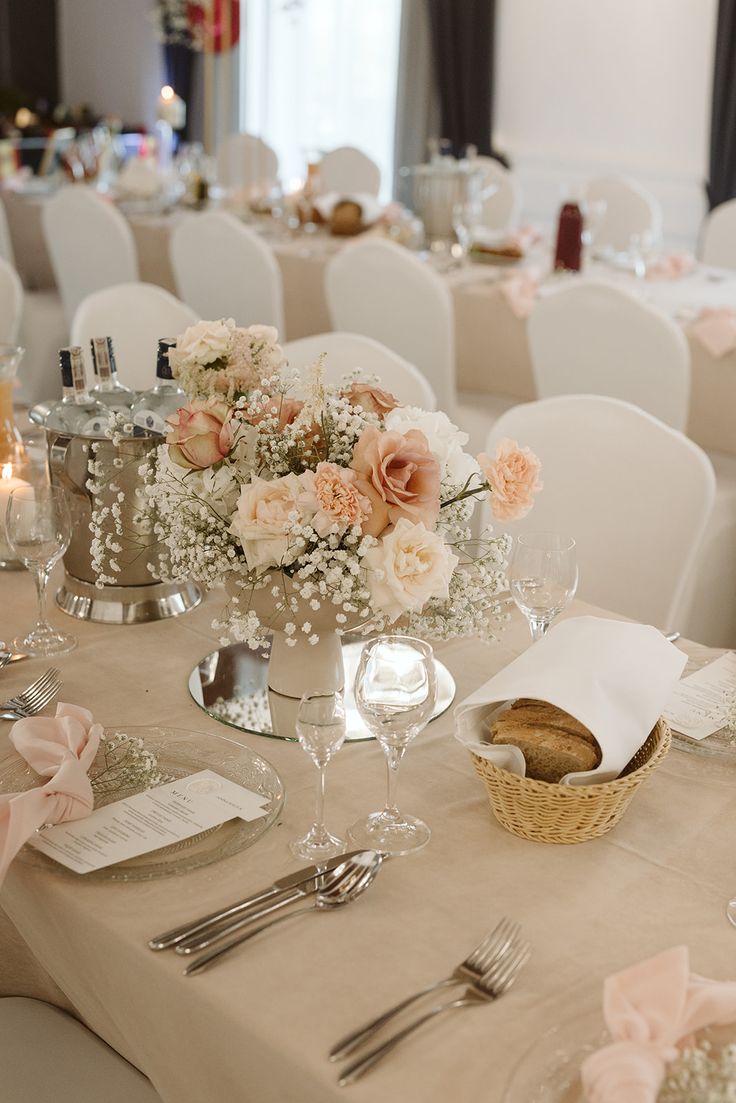 the table is set with silverware and flowers