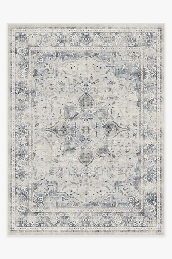 an area rug with blue and white designs on the front, in shades of gray