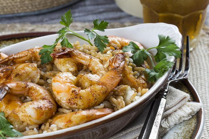 shrimp and rice with parsley garnish in a bowl