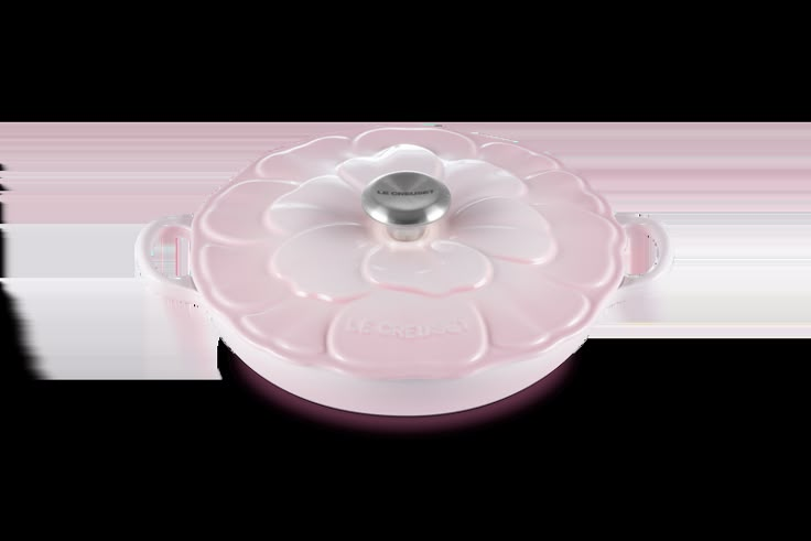 a pink flower shaped casserole dish on a white background