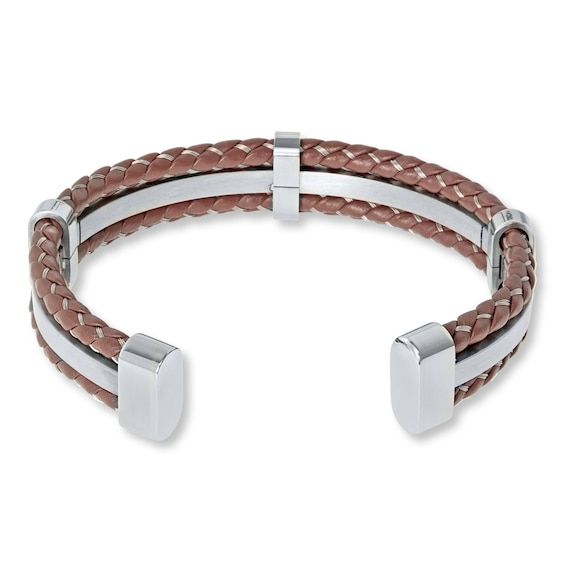 Braided brown leather flanks a band of gleaming stainless steel in this eye-catching men's bracelet. The cuff-style bracelet measures 7 inches in length. Modern Brown Bracelets For Formal Occasion, Brown Leather Bangle Bracelet, Modern Brown Leather Bracelet For Formal Occasions, Modern Brown Leather Formal Bracelet, Silver Leather Double Band Bracelets, Brown Double Band Bracelet With Leather Strap, Silver Leather Bangle Bracelet, Brown Double Band Jewelry With Leather Strap, Brown Double Band Leather Bracelets