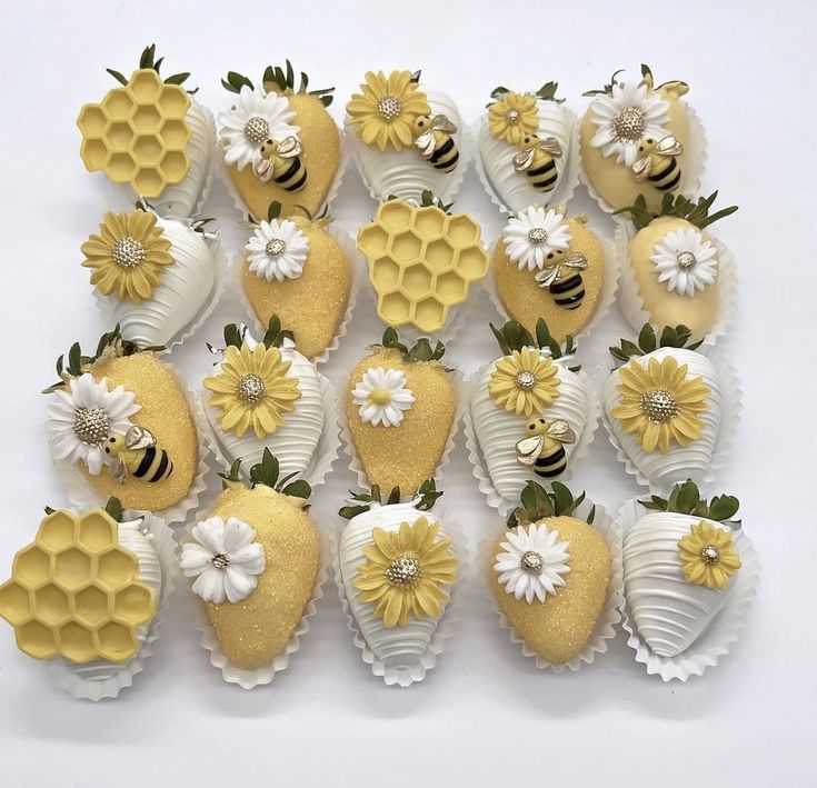 a bunch of strawberries with flowers and bees on them are arranged in the shape of hearts