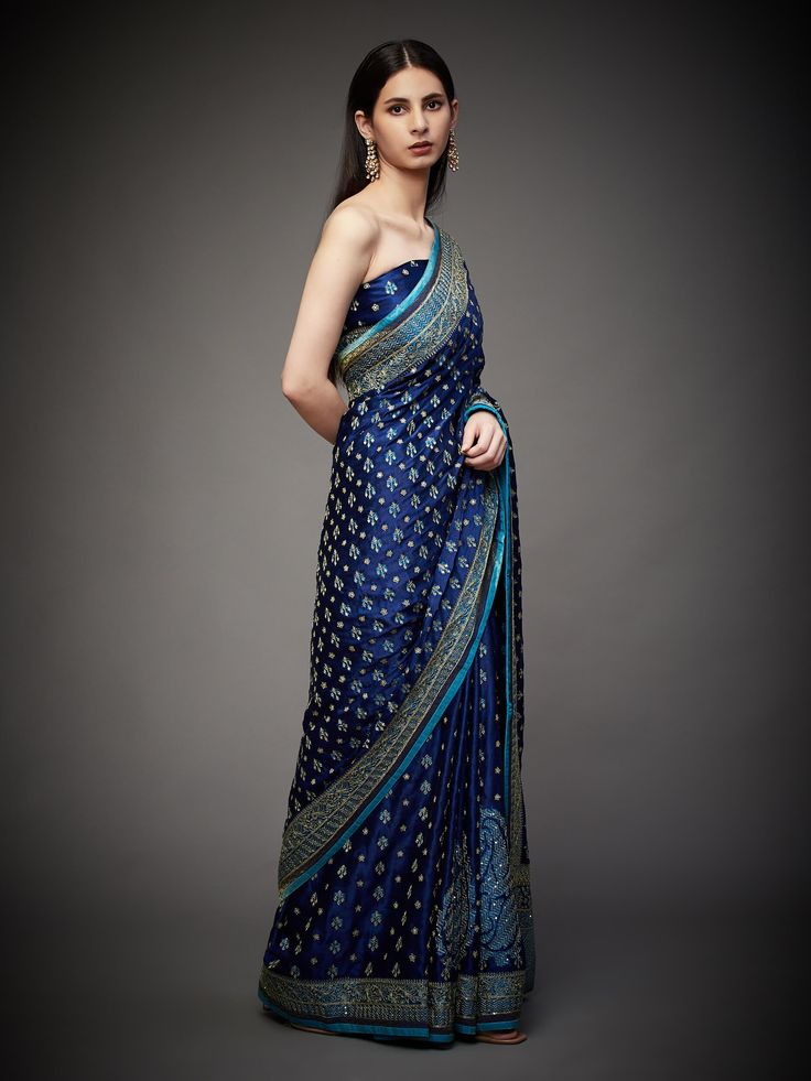 Editor's Note Embrace royal elegance with our royal/turquoise ari with tikki-h embroidered parampara ari 60 kasab sari, complete with an unstitched blouse. This ensemble is the epitome of traditional opulence, perfect for special occasions and events where you want to make a regal and sophisticated statement. The intricate embroidery and rich color combination ensure you stand out and leave a lasting impression. With the convenience of an unstitched blouse, you can customize your look to your li Satin Sari, Engagement Notes, Personal Shopping Service, Ritu Kumar, Ancient Designs, Satin Color, Intricate Embroidery, Color Combination, Silk Satin