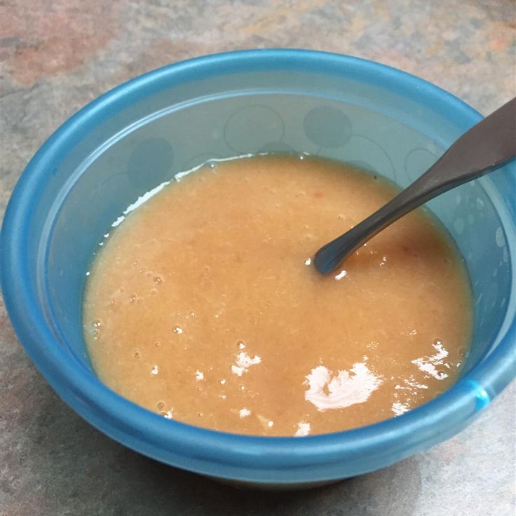 a blue bowl filled with liquid and a spoon