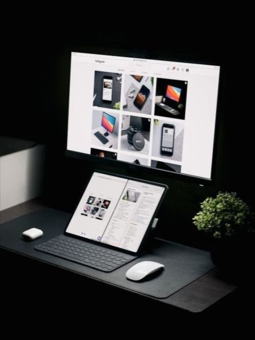 a computer monitor sitting on top of a desk next to a keyboard and mouse,