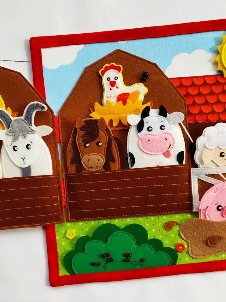 three felt farm animals in a red card