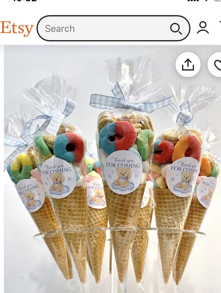 four ice cream cones with gummy bears in them on top of each other and the words etsy search below